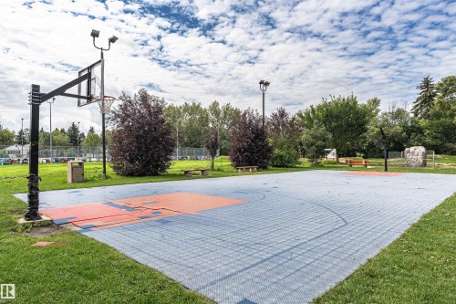 Outdoor sports court with blue and orange surfacing, surrounded by green landscaping - 11139 62 Avenue Nw, Edmonton, AB - Outdoor With View