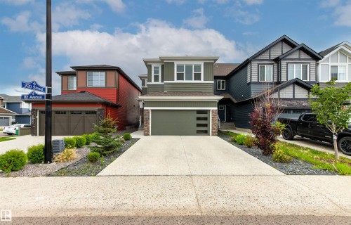 Two-story residence featuring a two-car garage, concrete driveway, and front landscaping with shrubs and rock accents - 22019 82 Avenue Nw, Edmonton, AB - Outdoor With Facade