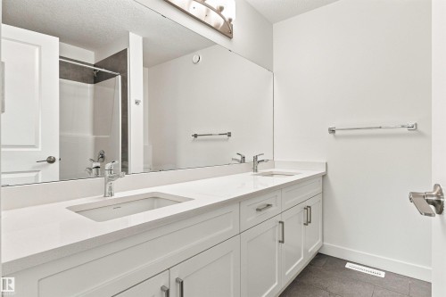 Dual vanity with integrated rectangular sinks and polished chrome fixtures - 22019 82 Avenue Nw, Edmonton, AB - Indoor Photo Showing Bathroom