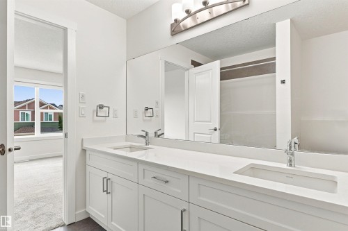 Dual vanity with integrated sinks and white cabinetry - 22019 82 Avenue Nw, Edmonton, AB - Indoor Photo Showing Bathroom