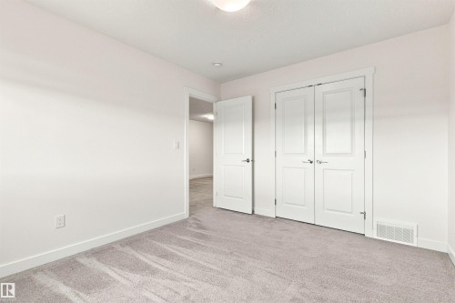 Light-colored wall-to-wall carpeting, white walls, white trim, and a white ceiling - 22019 82 Avenue Nw, Edmonton, AB - Indoor Photo Showing Other Room