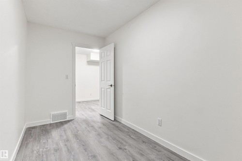 Pale gray wood-finish flooring - 22019 82 Avenue Nw, Edmonton, AB - Indoor Photo Showing Other Room