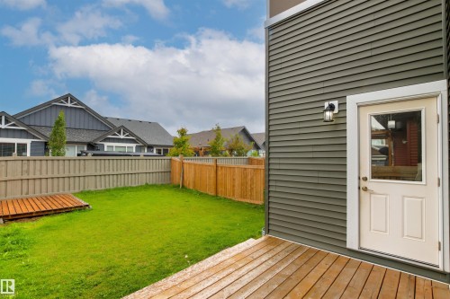 Private backyard featuring a manicured lawn, full fencing, and a wooden deck - 22019 82 Avenue Nw, Edmonton, AB - Outdoor With Deck Patio Veranda