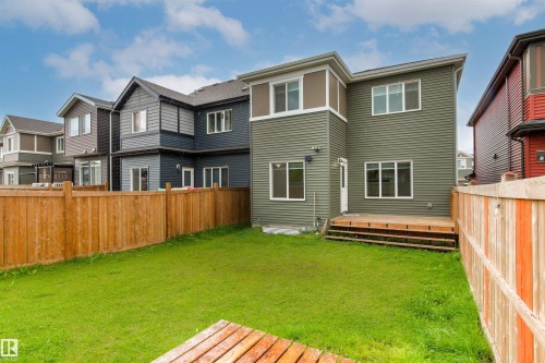 Expansive green lawn with a wood fence enclosure - 22019 82 Avenue Nw, Edmonton, AB - Outdoor With Deck Patio Veranda