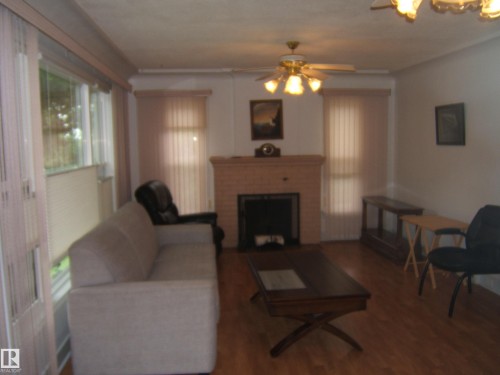 Living room - 4809 47A Street, Two Hills, AB - Indoor Photo Showing Living Room With Fireplace