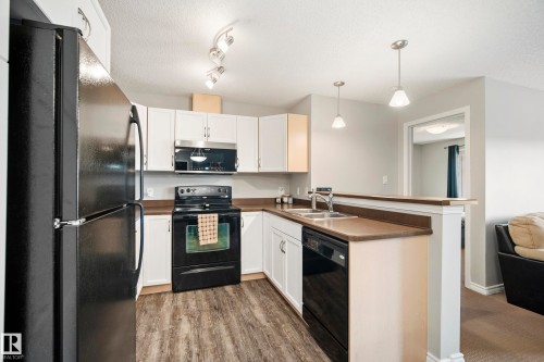 #340 2436 Guardian Rd Nw, Edmonton, AB - Indoor Photo Showing Kitchen With Double Sink