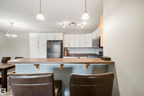#340 2436 Guardian Rd Nw, Edmonton, AB - Indoor Photo Showing Kitchen With Double Sink