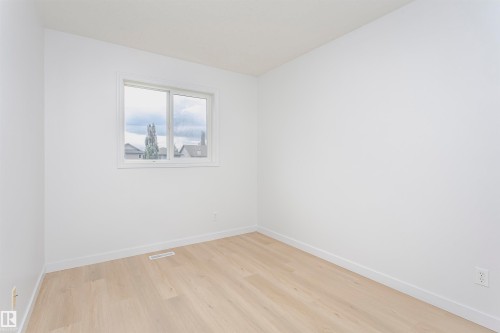 Light wood-finish flooring, white walls, and a white-framed window - 37 Suntree Promenade, Leduc, AB - Indoor Photo Showing Other Room
