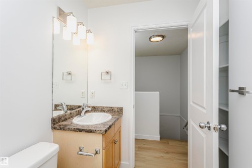 Vanity with a laminate countertop and undermount sink, overhead vanity lighting, and built-in shelving - 37 Suntree Promenade, Leduc, AB - Indoor Photo Showing Bathroom