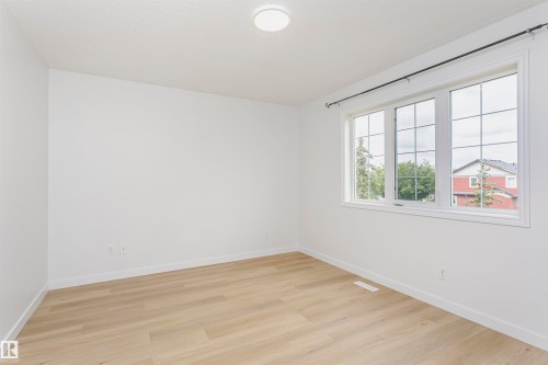 Recessed lighting with a flush-mount fixture, light wood-finish flooring, and white walls - 37 Suntree Promenade, Leduc, AB - Indoor Photo Showing Other Room