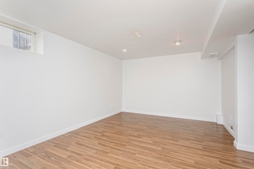Recessed lighting illuminates the wood-finish flooring in this expansive space, featuring a functional window - 37 Suntree Promenade, Leduc, AB - Indoor Photo Showing Other Room