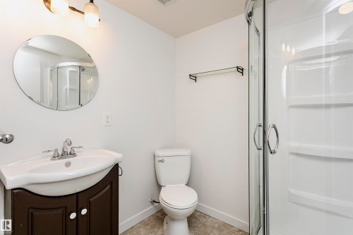 Integrated vanity with a white basin and dark wood-finish cabinetry - 37 Suntree Promenade, Leduc, AB - Indoor Photo Showing Bathroom