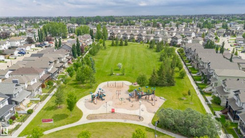 Expansive green space featuring a playground, walking paths, and mature trees - 37 Suntree Promenade, Leduc, AB - Outdoor With View