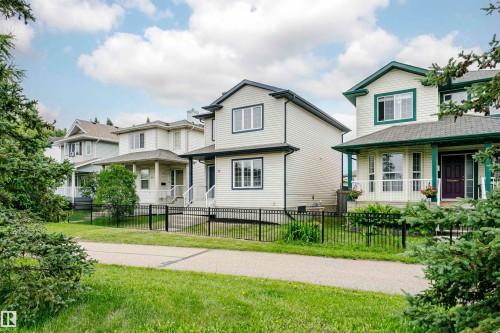 Siding exterior, multiple windows, covered front entry, and a black metal fence - 37 Suntree Promenade, Leduc, AB - Outdoor With Deck Patio Veranda With Facade