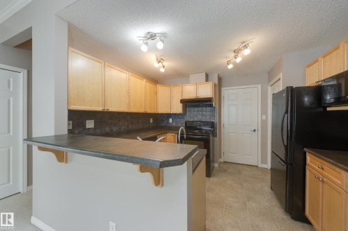 #20 3040 Spence Wd Sw, Edmonton, AB - Indoor Photo Showing Kitchen With Double Sink