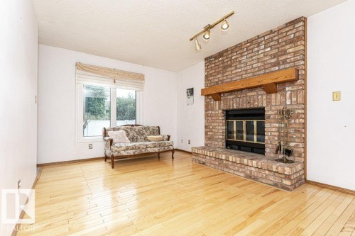 3303 42A Avenue Nw, Edmonton, AB - Indoor Photo Showing Living Room With Fireplace