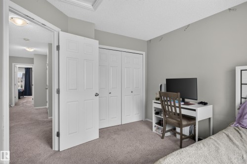 Carpeted flooring, bi-fold closet doors, and a ceiling light fixture - 17 Spruce Ridge Cove, Spruce Grove, AB - Indoor Photo Showing Bedroom