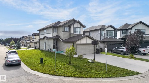 Elegant two-story residence featuring a contemporary exterior with mixed siding finishes, gabled rooflines, and multi-pane windows - 17 Spruce Ridge Cove, Spruce Grove, AB - Outdoor With Facade