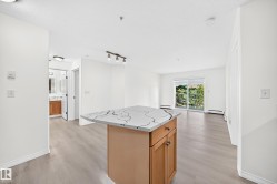 Kitchen island with a patterned countertop and wood-finish cabinetry - 