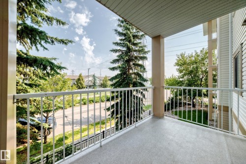 Private balcony featuring a textured concrete floor and white metal railings - #214 245 Edwards Dr Sw, Edmonton, AB - Outdoor With Balcony With Exterior
