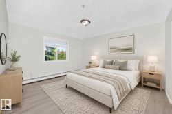 Spacious room featuring light wood-finish flooring, a contemporary window, and neutral wall tones - 