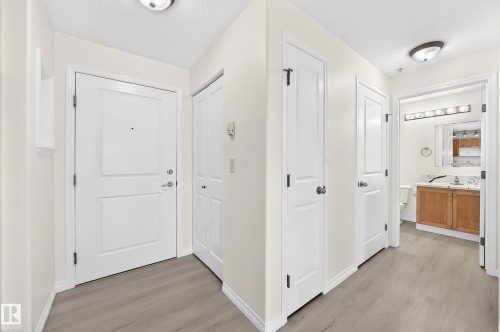 Entryway featuring light wood-finish flooring and a neutral color palette - #214 245 Edwards Dr Sw, Edmonton, AB - Indoor Photo Showing Other Room