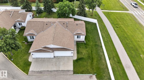 Aerial perspective showcasing a single-story residence with a brown shingle roof, light-colored siding, and a two-car garage - 8146 27 Avenue Nw, Edmonton, AB - Outdoor