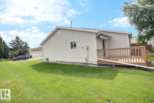 Wood deck with railing, featuring an attached retractable awning - 8146 27 Avenue Nw, Edmonton, AB - Outdoor With Deck Patio Veranda With Exterior