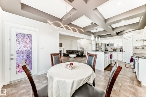 Open-concept living space featuring a coffered ceiling and contemporary lighting - 2812 12 Street Nw, Edmonton, AB - Indoor Photo Showing Dining Room