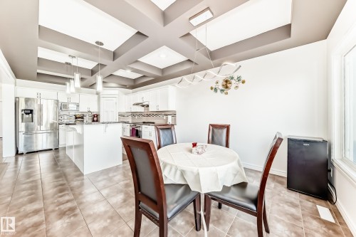 Kitchen and dining area featuring a coffered ceiling with recessed lighting - 2812 12 Street Nw, Edmonton, AB - Indoor Photo Showing Dining Room