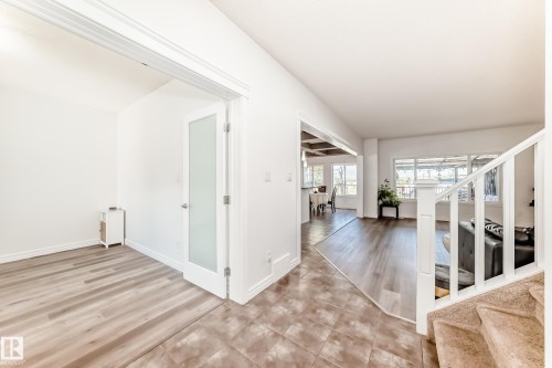 Entryway featuring square tile flooring, leading to an interior door with frosted glass panel - 2812 12 Street Nw, Edmonton, AB - Indoor Photo Showing Other Room