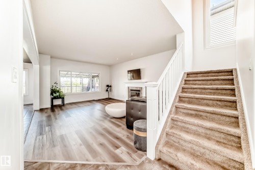 Carpeted staircase with white balusters leading to an upper level - 2812 12 Street Nw, Edmonton, AB - Indoor Photo Showing Other Room