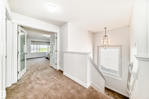 Upper-level hallway with plush brown carpeting and white trim - 2812 12 Street Nw, Edmonton, AB - Indoor Photo Showing Other Room