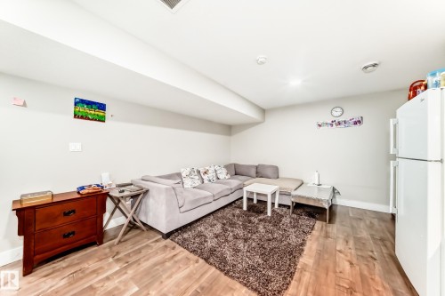 Finished lower level featuring wood-finish flooring, light-toned walls, and recessed lighting - 2812 12 Street Nw, Edmonton, AB - Indoor