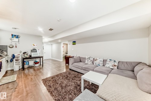 Open concept living area featuring wood-finish flooring, recessed lighting, and a white ceiling - 2812 12 Street Nw, Edmonton, AB - Indoor Photo Showing Living Room