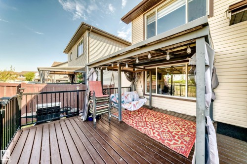 Multi-level wood-finish deck with black metal railings - 2812 12 Street Nw, Edmonton, AB - Outdoor With Deck Patio Veranda With Exterior