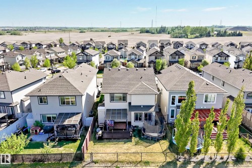 Rear exterior featuring a covered patio, fenced yard, and multi-level windows - 2812 12 Street Nw, Edmonton, AB - Outdoor