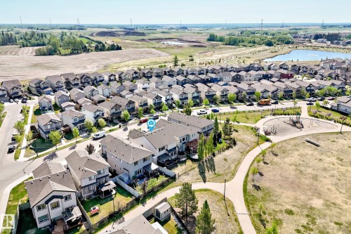 Residential neighborhood featuring a playground, paved walking paths, and a nearby pond - 2812 12 Street Nw, Edmonton, AB - Outdoor With View