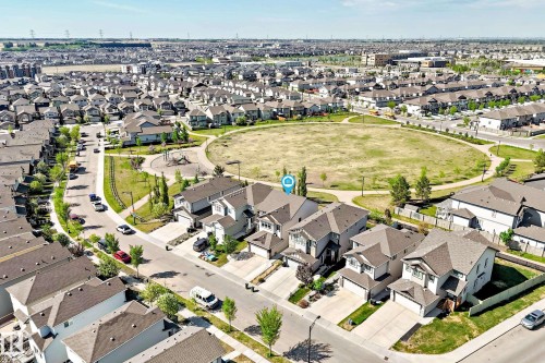 Residential neighborhood featuring single-family homes with attached garages, paved driveways, and manicured front lawns - 2812 12 Street Nw, Edmonton, AB - Outdoor With View
