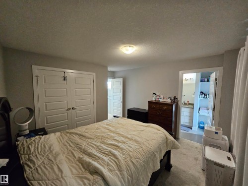 Recessed ceiling lighting, paneled interior doors, and carpet flooring - 15212 98 Avenue Nw, Edmonton, AB - Indoor Photo Showing Bedroom