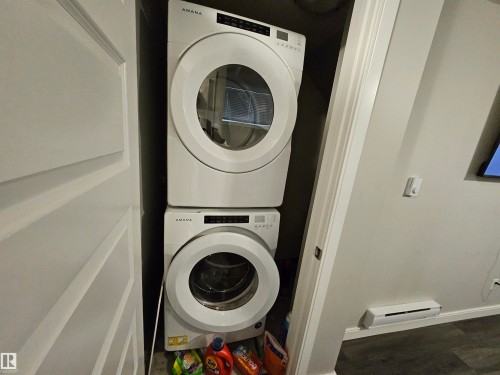 Stackable washer and dryer unit - 15212 98 Avenue Nw, Edmonton, AB - Indoor Photo Showing Laundry Room