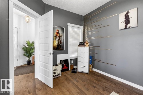 Hardwood-style flooring throughout - 3936 Claxton Loop Sw, Edmonton, AB - Indoor Photo Showing Other Room