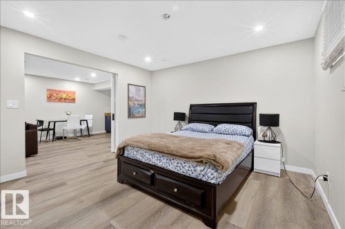 Recessed lighting illuminates wood-finish flooring throughout - 3936 Claxton Loop Sw, Edmonton, AB - Indoor Photo Showing Bedroom