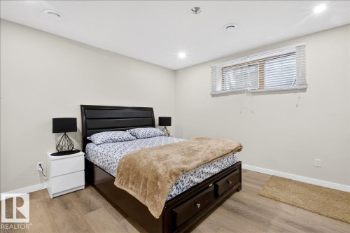 Recessed ceiling lighting, wood-finish flooring, and a window with blinds - 3936 Claxton Loop Sw, Edmonton, AB - Indoor Photo Showing Bedroom