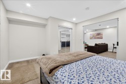 Recessed lighting, wood-finish flooring, sliding glass closet doors, open doorway, and neutral wall tones - 