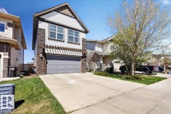 Contemporary exterior with siding and stone accents - 