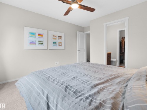Recessed lighting, wood-finish ceiling fan, neutral wall paint, carpeted flooring, and a white interior door - #89 603 Watt Bv Sw, Edmonton, AB - Indoor Photo Showing Bedroom