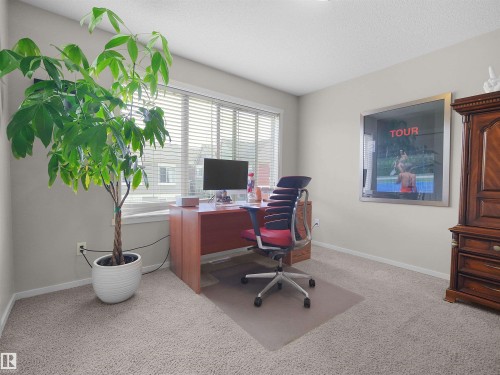 Carpet flooring, neutral painted walls, and window with horizontal blinds - #89 603 Watt Bv Sw, Edmonton, AB - Indoor Photo Showing Office