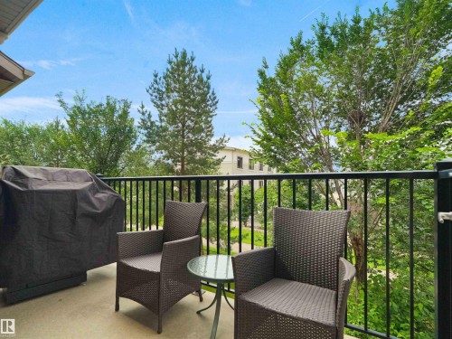 Outdoor balcony with concrete flooring and black metal railings - #89 603 Watt Bv Sw, Edmonton, AB - Outdoor With Balcony With Exterior