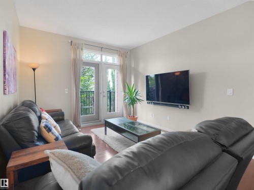 Wood-finish flooring throughout - #89 603 Watt Bv Sw, Edmonton, AB - Indoor Photo Showing Living Room